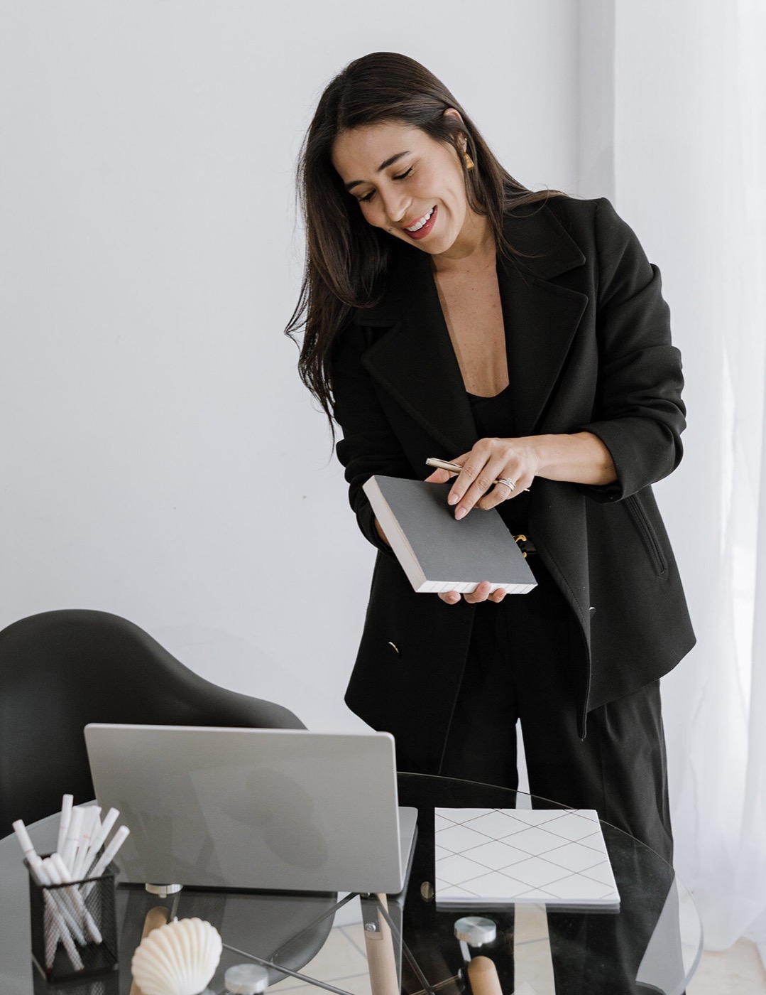Practitioner with notebook and laptop